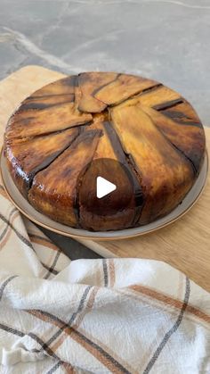 a cake sitting on top of a wooden cutting board