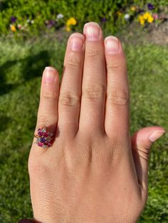 The Hempstead Bubblegum Ruby & Diamond Cocktail Ring. The ring features a reddish purple sapphire center stone with vivid red natural rubies and pink sapphires cascading from the center. Mixed between are diamonds throughout. The ring contains approximately 2 carats total weight by measurement of rubies and sapphires. The total estimated diamond weight by measurement is 0.36 carats. The ring is crafted in 14 karat yellow gold and is currently a finger size 6 yet can be adjusted to any finger Cluster Ruby Ring With Diamonds, Cluster Red Ruby Ring With Multi-stones, Cluster Red Multi-stone Ruby Ring, Red Ruby Diamond Multi-stone Ring, Red Ruby Multi-stone Ring With Diamonds, Cluster Ruby Ring With Center Stone, Red Multi-stone Sapphire Ring, Pink Diamond Cluster Ring With Multi-stone, Pink Diamond Cluster Ruby Ring