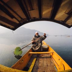 a man sitting in a yellow boat on the water