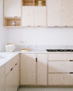 a kitchen with wooden cabinets and white counter tops