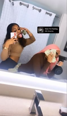 a woman taking a selfie in front of a bathroom mirror with money sticking out of her mouth