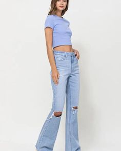 Crafted from non-stretch denim, these jeans capture the essence of the era with distressed detailing and a super high-waisted fit. The relaxed legs and wide flare design evoke a sense of nostalgia, while the authentic rigid jeans texture adds to their vintage appeal. Front Rise: 11 1/2", Inseam: 32", Leg Opening: 18"Model is 5' 9'' wearing size 26 Style: Casual Print / Pattern: Plain Silhouette: Vintage Flare Fit: Regular Embellishment: Distressed detail Neck Line: NA Sleeve: NA Length: Up to 44 Cropped Denim Flare Jeans With Five Pockets, High Rise Ripped Light Wash Flare Jeans, Trendy Medium Wash Cropped Flare Jeans, Cropped Denim Blue Flare Jeans With Frayed Hem, Cropped Denim Flare Jeans With Frayed Hem, Cropped Light Wash Flare Jeans For Fall, Cropped Flare Jeans With Frayed Hem, Ripped Cropped Jeans For Fall, High Waist Ripped Flare Jeans For Spring