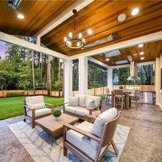 an outdoor living area with furniture and lights