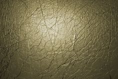 the texture of an old leather surface is very dark green and shiny with white highlights