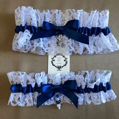 Something new & something blue. Any order can be customized to YOUR wedding colors. Created with 5/8" navy blue satin ribbon and white lace. Centered w/ coordinating ribbons, initial charm and beads. The charm is approximately 1/2" x 1/2" choose initial charm at checkout. Please note that beading, lace or ribbon may be different, as I try to individualize each one, I do use the same number of beads and the same amount of lace & ribbon. I can add any accent colors to coordinate with your wedding. The smaller garter is 2.5" wide, larger garter is 3.5" wide. The set includes one of each. The larger garter has the initial charm & the smaller garter has beads. If only 1 garter is ordered, it will have the initial charm. Garters relaxed are 14" and stretch comfortably to 24".  Larger sizes may b Personalized Wedding Garter, Pink Garter, White Lace Garter, Lace Wedding Garter Set, Wedding Garter Blue, Bridal Garter Lace, Lace Garter Set, Bridesmaid Headband, Blue Bride