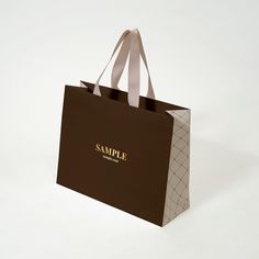 a brown shopping bag with the word sample printed on it's front and side