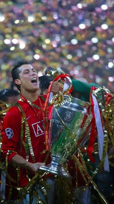 the soccer player is celebrating with his trophy