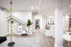 a living room filled with furniture and white walls