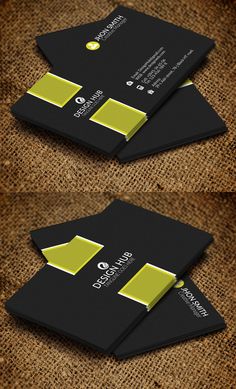 two black and yellow business cards sitting on top of each other