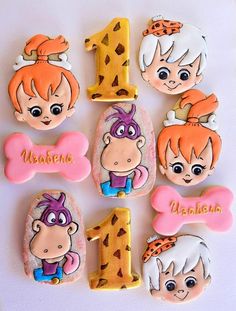 a number one decorated cookie with cartoon characters