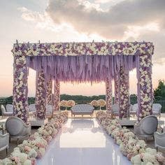 an outdoor wedding setup with flowers and tulle