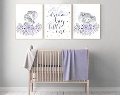 two prints on the wall of a baby's room with a crib and blanket