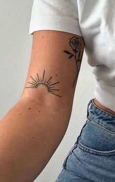 a woman's arm with a tattoo on it and a rose in the middle