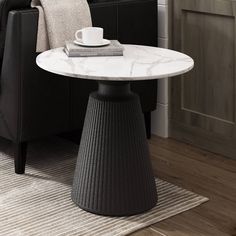 a white marble top table in a living room with black chair and coffee cup on it