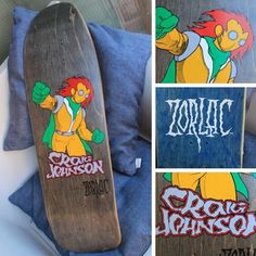 the simpsons skateboard has been painted on and is sitting on a pillow in front of some pillows