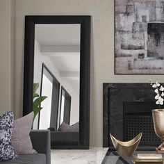 a living room filled with furniture and a large mirror on the wall over a fireplace