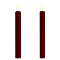 two red candles sitting next to each other