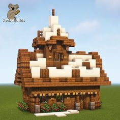 a small house made out of wood and white snow on the roof, with a koala logo above it