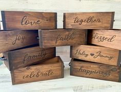 six wooden boxes with different names on them