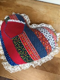 a heart shaped pillow sitting on top of a doily