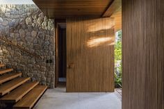 an entry way with stone walls and wooden steps