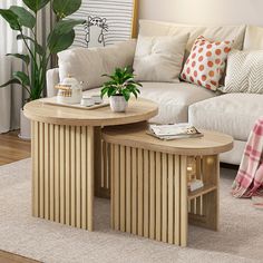 two coffee tables sitting on top of a rug in front of a couch and table