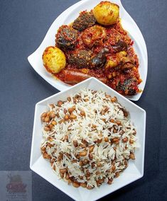 two white plates filled with different types of food on top of a black tablecloth