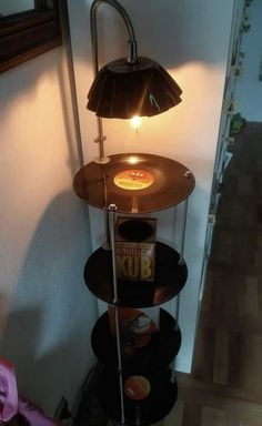 a lamp that is sitting on top of a shelf next to a record player's turntable