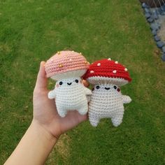 two small crocheted stuffed animals are held in the palm of someone's hand