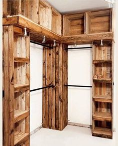 an empty room with wooden shelves and shelving unit in it's center area