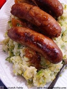 two sausages and rice on a white plate