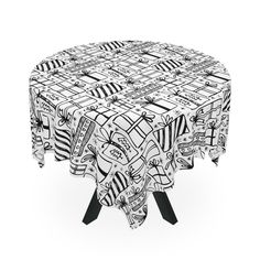 a black and white table cloth on top of a round table with an abstract design