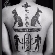 the back of a man's body with egyptian symbols and anub on it