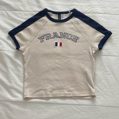 H&M “France” Baby Tee. New Without Tags / Has Never Been Worn Before. Size Women’s Small. No Flaws And In Perfect Condition. Cute H&m Crew Neck Top, H&m Sporty Crew Neck Tops, Sporty H&m Crew Neck Tops, Cute Cream Tops With Letter Print, Sporty Spring Tops By H&m, Sporty Spring Tops From H&m, Sporty H&m Tops For Spring, Sporty Cream Tops With Letter Print, Blue Crew Neck Tops By H&m