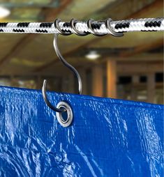 a blue tarp with a metal hook hanging from it's side in a warehouse