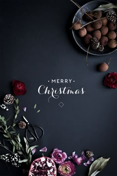 a christmas card with flowers and berries in the center on a black background that says merry christmas