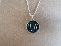 a silver necklace with roman numerals on it