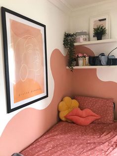 a small bed in a room with pink and white decor on the walls, shelves above it