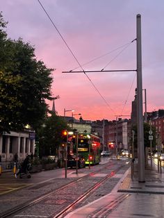 a city street at dusk with traffic on the road