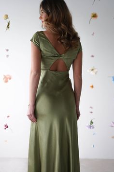 a woman in a green dress looking back