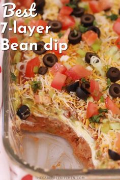 an easy mexican dip recipe with black olives, tomatoes, cheese and other toppings