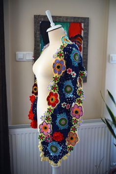 a white mannequin with colorful flowers on it