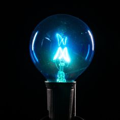 a blue light bulb sitting on top of a black table