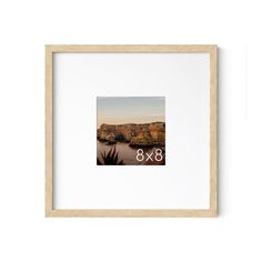 a white framed photograph with the number eight 8x8 in it's center