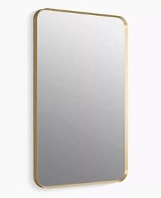 a mirror mounted to the side of a wall next to a white wall with a gold frame