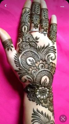 the hand is decorated with henna on it