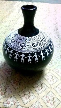 a black and white vase sitting on top of a table