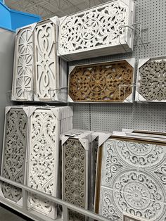 several decorative items are on display in a store, including white cabinets and wooden doors