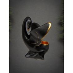 a black and gold cat figurine hanging from a christmas tree ornament