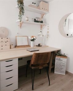 a white desk with a brown chair in front of it and shelves on the wall